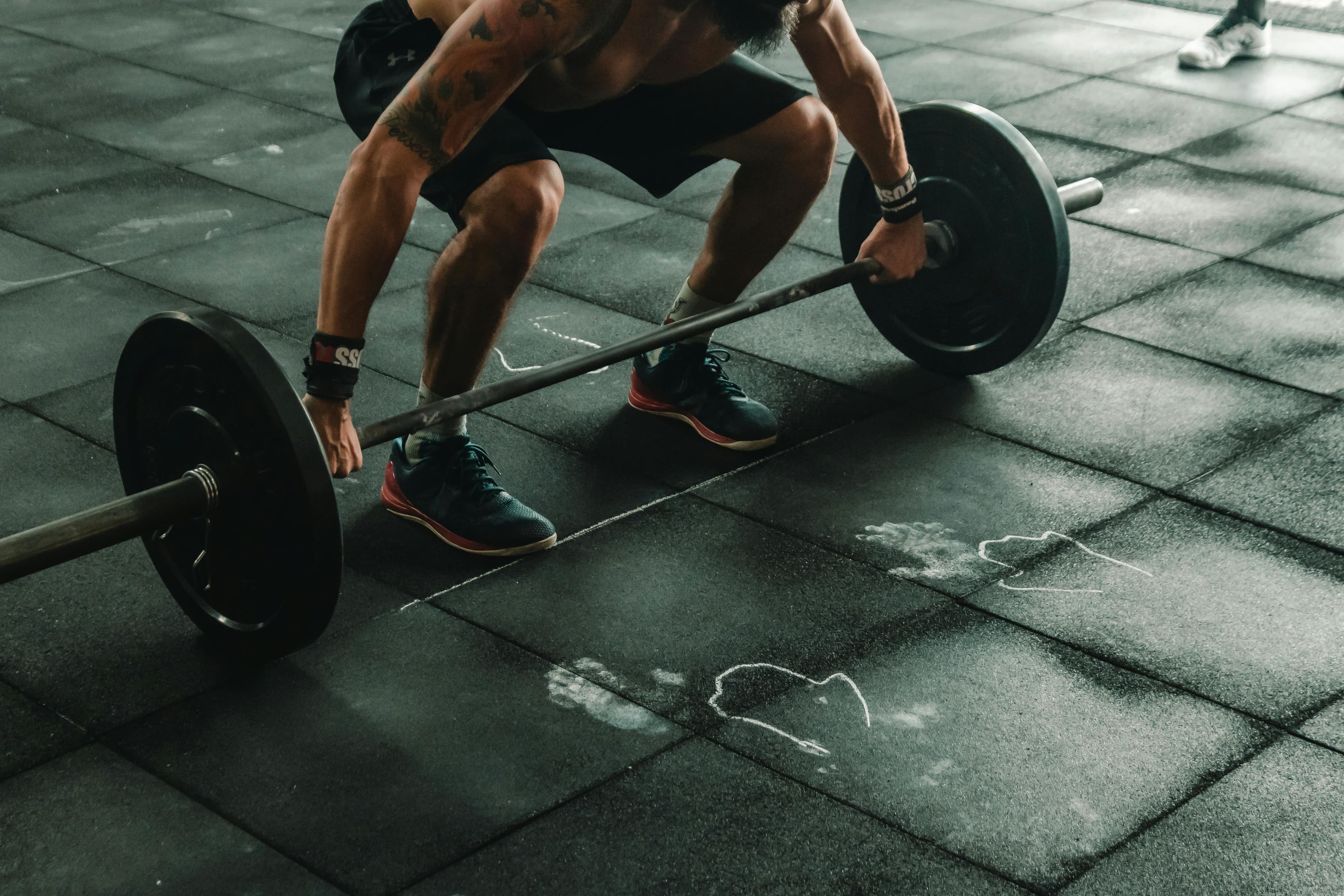 Person performing deadlift in training facility